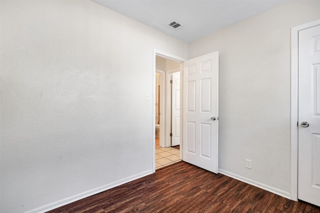 unfurnished bedroom featuring dark hardwood / wood-style floors