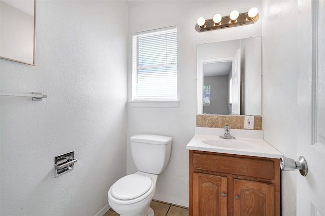 bathroom with vanity, toilet, and tile patterned floors