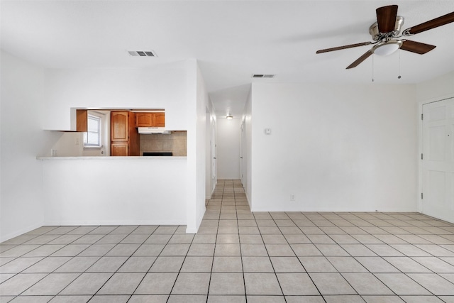 unfurnished living room with ceiling fan and light tile patterned floors