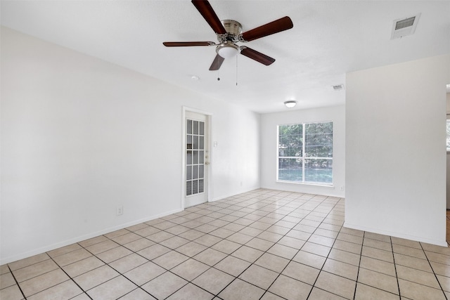 tiled spare room with ceiling fan