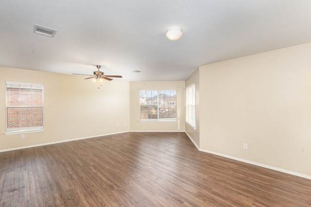 spare room with dark hardwood / wood-style flooring and ceiling fan