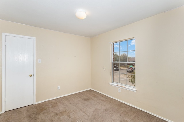 spare room featuring light colored carpet