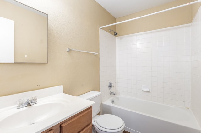 full bathroom featuring toilet, vanity, and tiled shower / bath