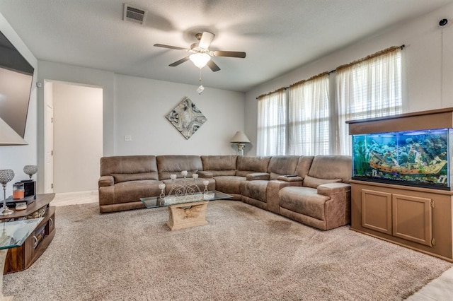 carpeted living room featuring a textured ceiling and ceiling fan