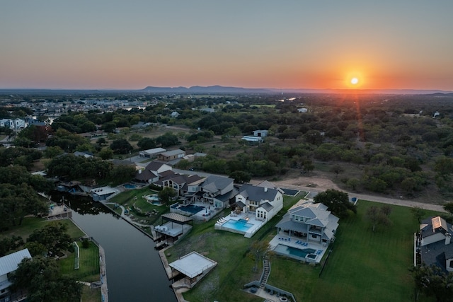 aerial view at dusk with a water view