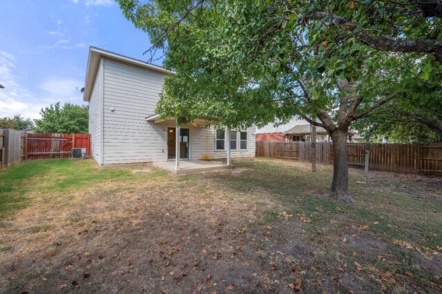 back of house featuring a patio area, central AC, and a lawn