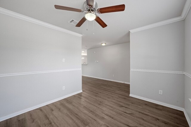 spare room with ornamental molding, dark hardwood / wood-style floors, and ceiling fan