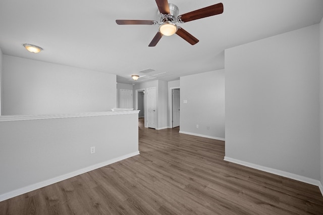 spare room with ceiling fan and dark hardwood / wood-style flooring