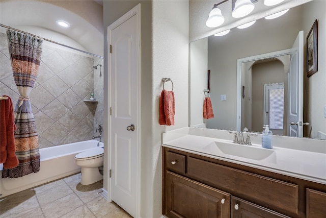 full bathroom featuring vanity, shower / bath combo with shower curtain, toilet, and tile patterned flooring