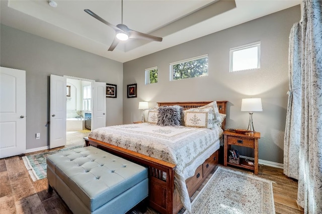 7618 Turnback Ledge Trl, Lago Vista, TX 78645 - bedroom with wood finished floors, baseboards, ensuite bath, and a ceiling fan