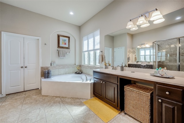 bathroom with vanity, independent shower and bath, and tile patterned flooring