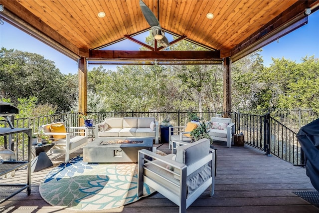 wooden deck featuring a gazebo, an outdoor living space, and ceiling fan