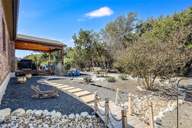 view of yard featuring a patio area and a wooden deck