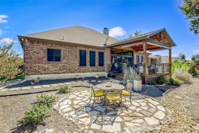 7618 Turnback Ledge Trl, Lago Vista, TX 78645 - rear view of house with a patio area, a deck, a chimney, and brick siding