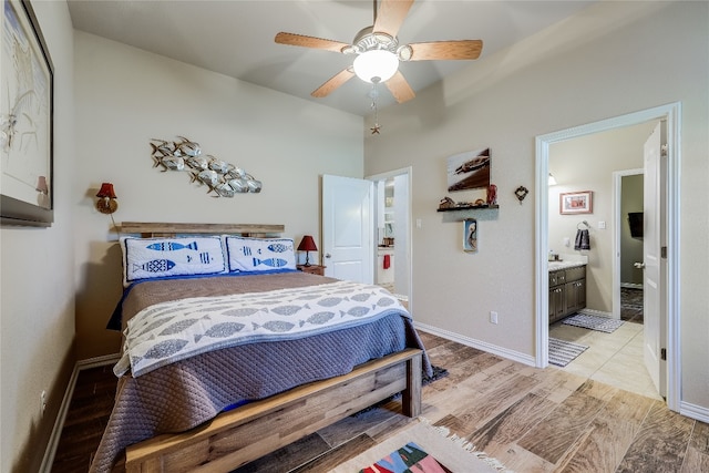 bedroom with ensuite bath, light wood-type flooring, and ceiling fan