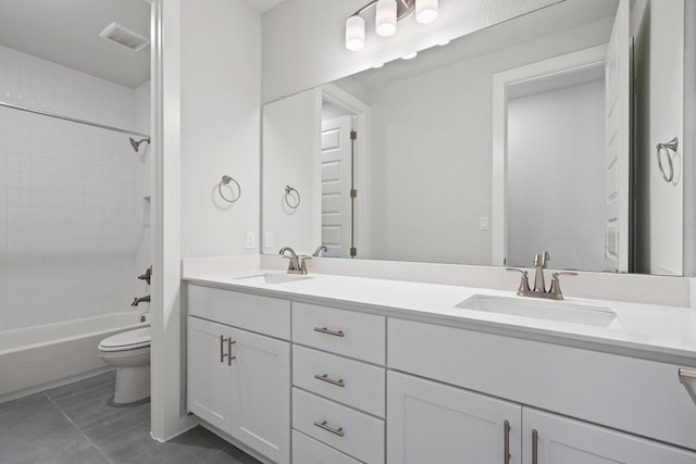 full bathroom featuring vanity, tiled shower / bath combo, toilet, and tile patterned flooring