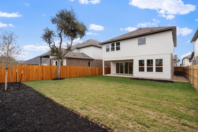 rear view of property with a patio area, central AC, and a yard