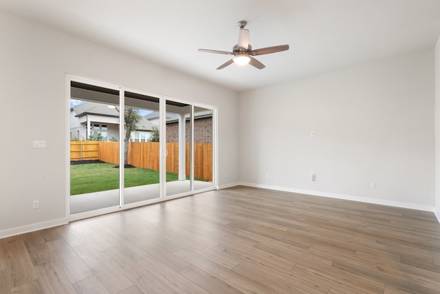 unfurnished room with hardwood / wood-style floors and ceiling fan