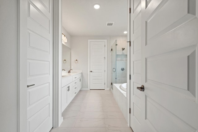 bathroom featuring vanity and shower with separate bathtub