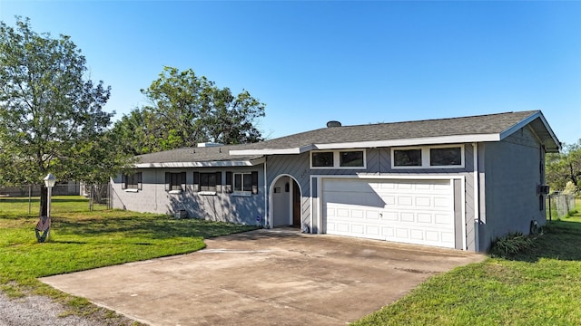 ranch-style home with a front lawn and a garage