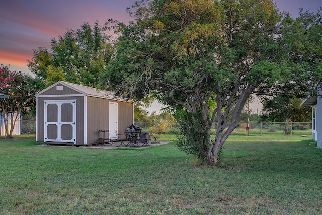 outdoor structure at dusk featuring a lawn