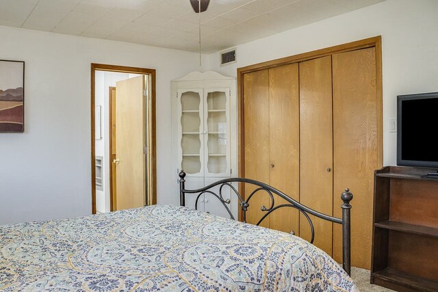 bedroom featuring carpet, a closet, and ceiling fan