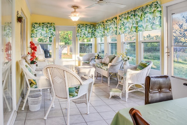 sunroom with lofted ceiling, a healthy amount of sunlight, and ceiling fan