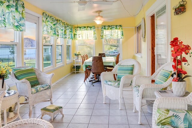 sunroom featuring ceiling fan, vaulted ceiling, and plenty of natural light