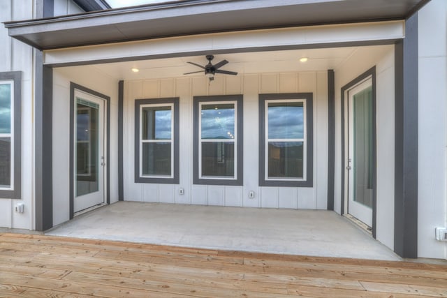 property entrance with a wooden deck, a patio area, and ceiling fan