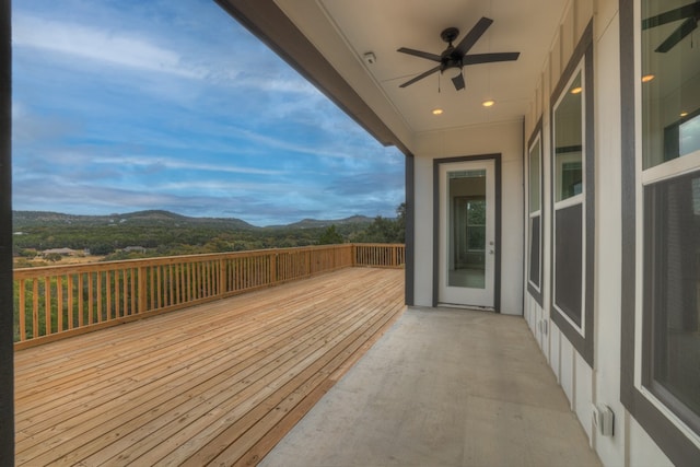 deck with a mountain view and ceiling fan