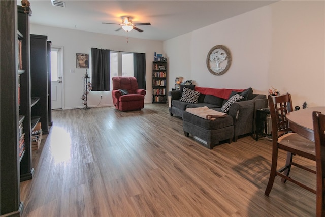 living room with wood-type flooring and ceiling fan