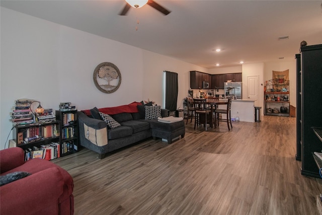 living room with hardwood / wood-style flooring and ceiling fan