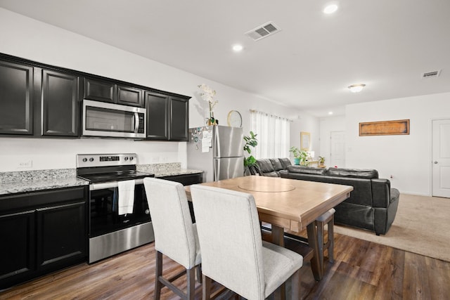 dining space with dark hardwood / wood-style floors