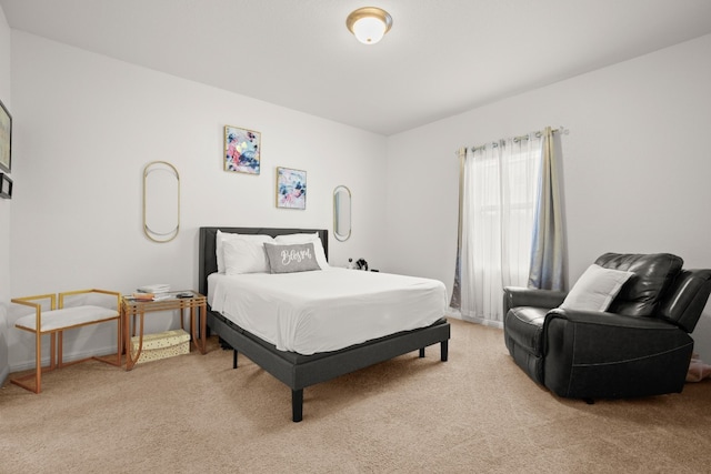 bedroom featuring light colored carpet