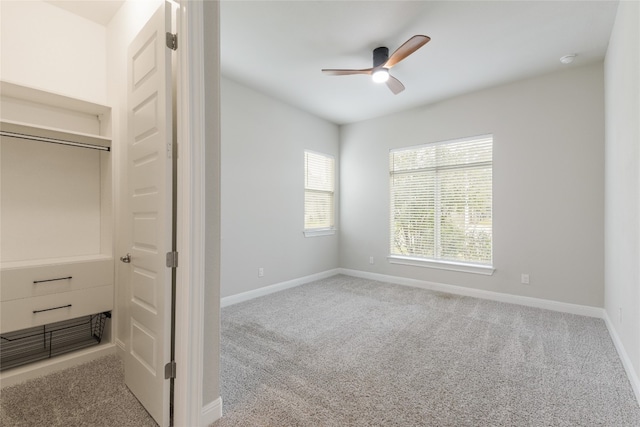 unfurnished bedroom featuring a closet, light colored carpet, and ceiling fan