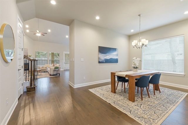 dining area featuring dark wood-type flooring, high vaulted ceiling, and ceiling fan with notable chandelier