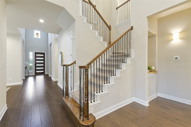 foyer featuring dark hardwood / wood-style floors and a high ceiling