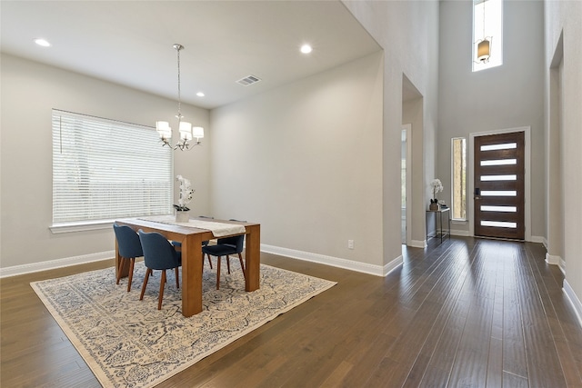 dining area with dark hardwood / wood-style floors, a chandelier, and plenty of natural light