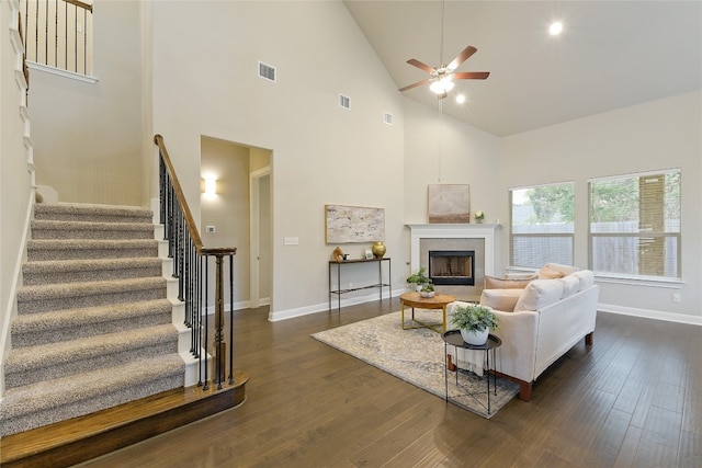 living room featuring ceiling fan, high vaulted ceiling, and dark hardwood / wood-style flooring