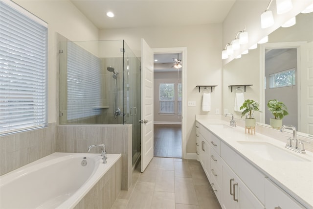 bathroom featuring vanity, a healthy amount of sunlight, independent shower and bath, and tile patterned floors