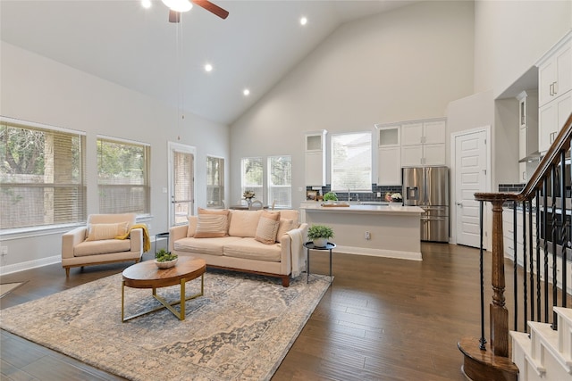 living room with high vaulted ceiling, a healthy amount of sunlight, dark hardwood / wood-style floors, and ceiling fan