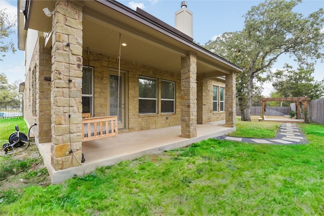 back of property featuring a patio area and a lawn