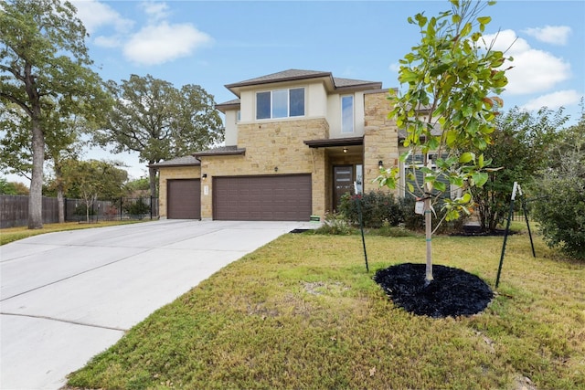 view of front of home with a garage and a front lawn