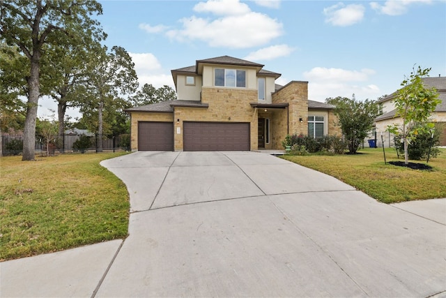 prairie-style home with a front yard and a garage