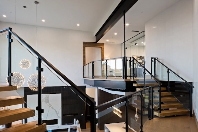 staircase with hardwood / wood-style flooring