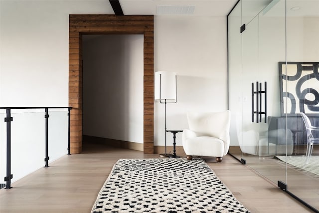 sitting room featuring light hardwood / wood-style floors