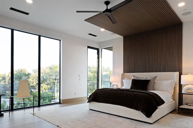 bedroom featuring access to outside, ceiling fan, and light hardwood / wood-style flooring