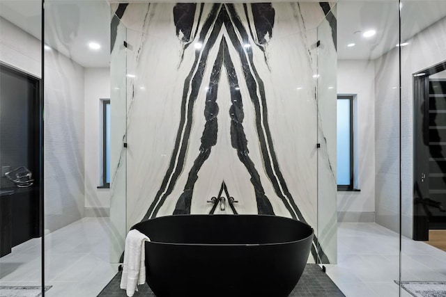 300 Stonewall Ln, Austin, TX 78746 - bathroom featuring a soaking tub and tile patterned floors