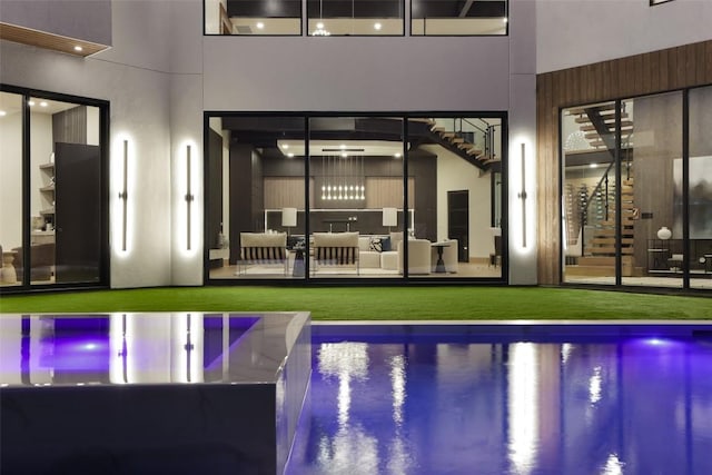 300 Stonewall Ln, Austin, TX 78746 - back of property with an outdoor pool, stucco siding, and an outdoor living space