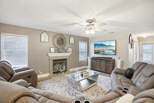 living room featuring a wealth of natural light, ceiling fan, and light hardwood / wood-style floors